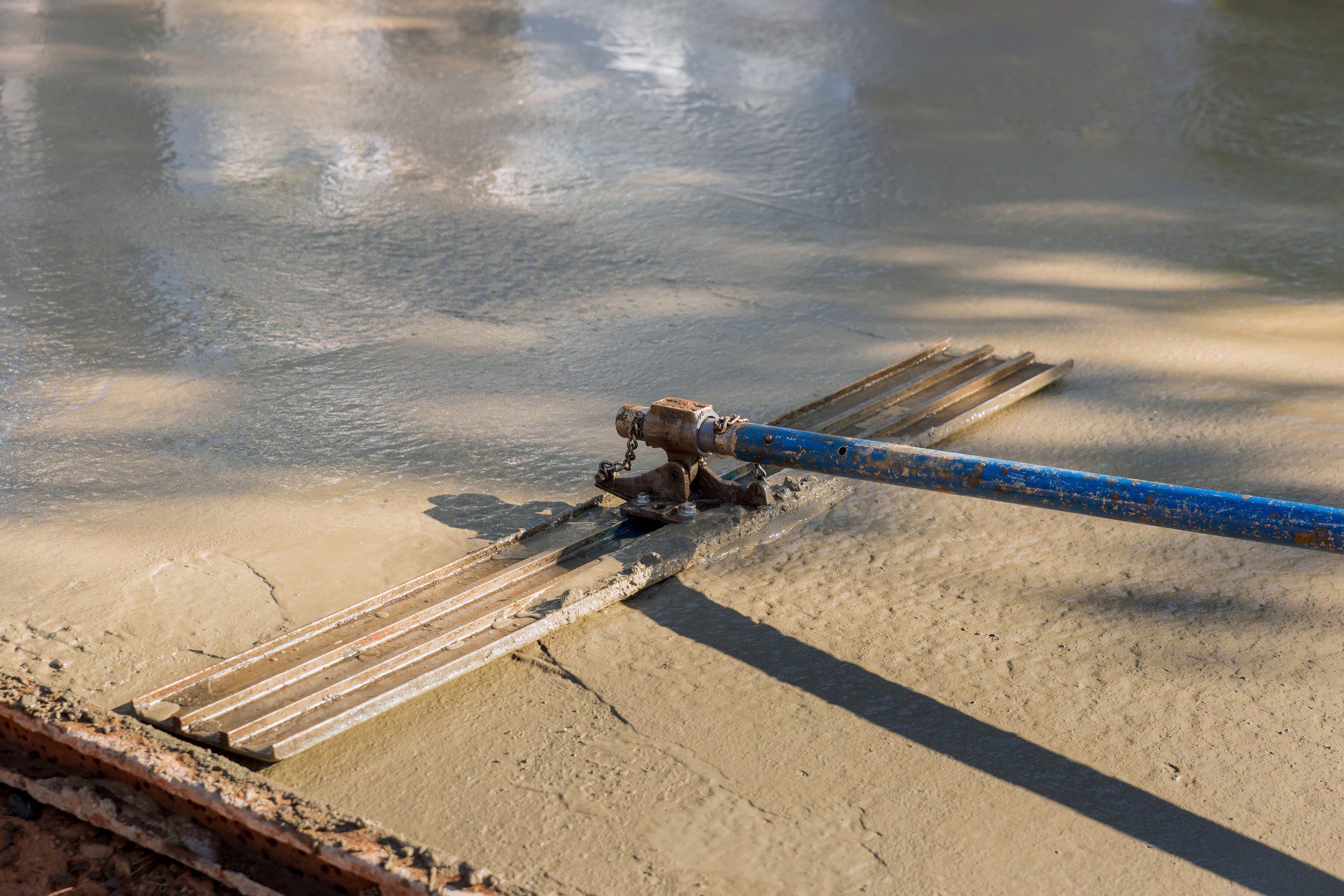 Workers Leveling Concrete For Driveway On Construc 2023 10 02 17 47 29 Utc
