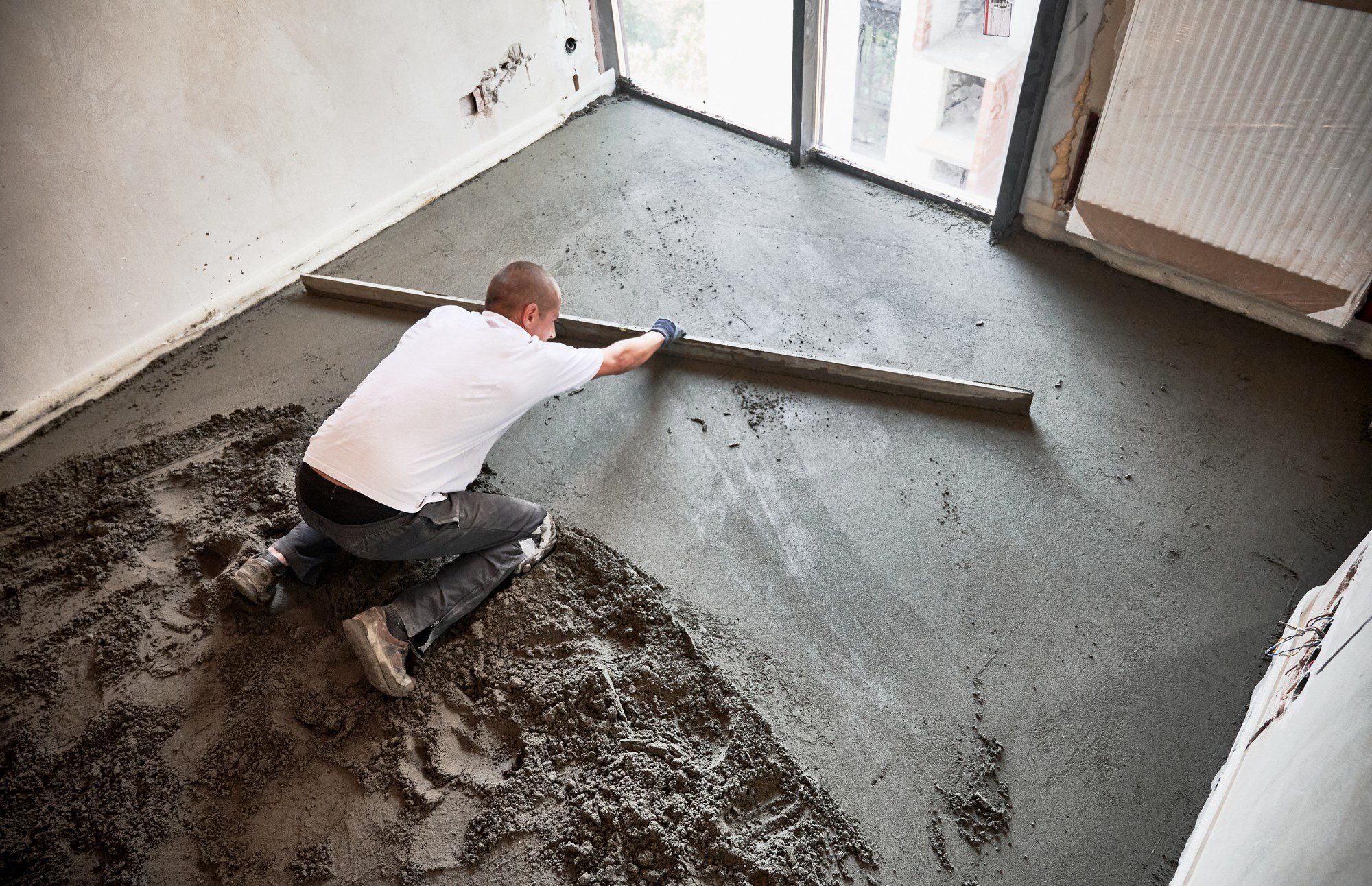 Man Screeding Floor In Apartment During Renovation 2023 03 13 18 38 43 Utc